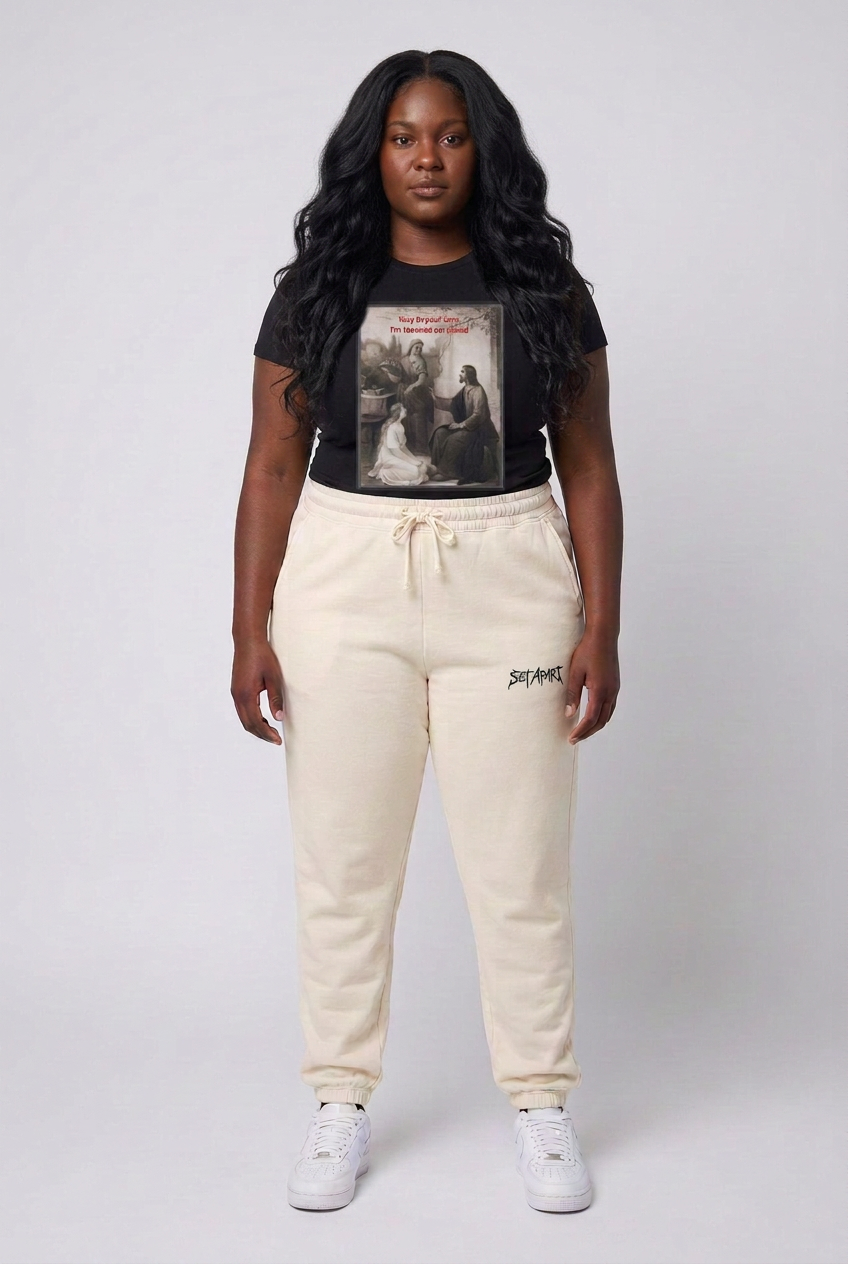 Same model with long wavy black hair in ivory Set Apart sweatpants
